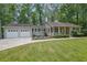 Well-maintained home with a 2-car garage, complemented by a lush green lawn and manicured landscaping at 4516 Creekwood Circle Nw, Kennesaw, GA 30152