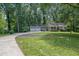 Charming home featuring a two-car garage, lush lawn, and well-manicured landscaping at 4516 Creekwood Circle Nw, Kennesaw, GA 30152