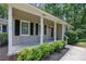 Inviting front porch with black trimmed windows and door and well-maintained landscaping at 4516 Creekwood Circle Nw, Kennesaw, GA 30152
