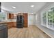 Well-lit kitchen with wood cabinets, stainless steel appliances, granite countertops, and wood-look flooring at 4516 Creekwood Circle Nw, Kennesaw, GA 30152