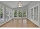 Bright sunroom with many windows, light walls, a ceiling fan, and french doors at 4516 Creekwood Circle Nw, Kennesaw, GA 30152