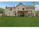Large, grassy backyard with a covered patio and exterior view of the house at 75 Hunters Ct, Dallas, GA 30157