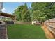 Expansive backyard featuring a covered patio, shed, and a well-maintained lawn at 75 Hunters Ct, Dallas, GA 30157