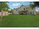 Lush backyard featuring a spacious lawn and a covered patio with outdoor seating at 75 Hunters Ct, Dallas, GA 30157