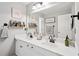 Elegant bathroom featuring double sinks, framed mirrors, and decorative accents at 75 Hunters Ct, Dallas, GA 30157