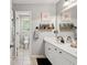 Well-lit bathroom with double sinks, decor, and an adjacent toilet area at 75 Hunters Ct, Dallas, GA 30157
