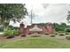 Hunters Glen community entrance featuring a beautiful brick sign and landscaped garden at 75 Hunters Ct, Dallas, GA 30157