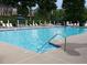 Community pool with lounge chairs and umbrellas for relaxing and enjoying the outdoors at 75 Hunters Ct, Dallas, GA 30157