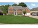 Charming two-story brick home featuring a manicured lawn, tasteful landscaping, and an attached two-car garage at 75 Hunters Ct, Dallas, GA 30157