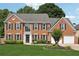 Traditional two-story brick home with a well-manicured lawn and a two car attached garage at 75 Hunters Ct, Dallas, GA 30157
