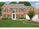 Traditional two-story brick home with a well-manicured lawn and a two car attached garage at 75 Hunters Ct, Dallas, GA 30157