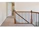 Hallway with carpet flooring, painted walls, and oak railing at 75 Hunters Ct, Dallas, GA 30157