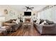 Inviting living room with a brick fireplace, built-in shelving, ceiling fan, and comfortable sofas for relaxation at 75 Hunters Ct, Dallas, GA 30157