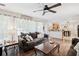 Open-concept living area featuring hardwood floors, comfortable sofas, and a view of the kitchen and backyard at 75 Hunters Ct, Dallas, GA 30157