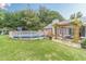 Backyard featuring a pool, playground, patio with outdoor seating, and a well-manicured lawn at 123 Chippewa Run, Auburn, GA 30011