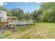 Backyard with above ground pool, basketball court and mature trees at 123 Chippewa Run, Auburn, GA 30011