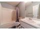 Bathroom with tub-shower combo, single sink vanity, and neutral color scheme at 123 Chippewa Run, Auburn, GA 30011
