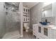 Bathroom with gray tiled shower, toilet, and sink with blue vessel sink and gray tiled backsplash at 123 Chippewa Run, Auburn, GA 30011