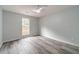 This bedroom offers gray walls, wood-look flooring, and natural light from a window at 123 Chippewa Run, Auburn, GA 30011