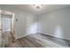 Bedroom featuring gray walls, wood-look flooring, and a door leading to the hallway at 123 Chippewa Run, Auburn, GA 30011