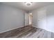 Bedroom featuring gray walls, wood-look flooring, and two white doors at 123 Chippewa Run, Auburn, GA 30011