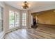 Bright breakfast nook with wood-look floors, views to the back yard, and a stylish light fixture at 123 Chippewa Run, Auburn, GA 30011