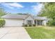 Charming single-story home with a well-maintained lawn and attached two-car garage in a quiet neighborhood at 123 Chippewa Run, Auburn, GA 30011