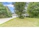 Inviting single-story home featuring a lush front yard, mature trees, and attached two-car garage at 123 Chippewa Run, Auburn, GA 30011