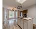 Kitchen island with sink, wood-look floors, a skylight, and a view to the breakfast nook at 123 Chippewa Run, Auburn, GA 30011