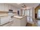 Kitchen with white cabinets, a kitchen island with a sink, and modern appliances at 123 Chippewa Run, Auburn, GA 30011