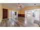 Open living room with wood-look floors and views to the entry, kitchen and breakfast nook at 123 Chippewa Run, Auburn, GA 30011