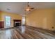 Living room featuring a fireplace, wood-look floors, and a door to the backyard at 123 Chippewa Run, Auburn, GA 30011