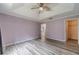 Main bedroom featuring tray ceilings, a fan, and entrances to a closet and bathroom at 123 Chippewa Run, Auburn, GA 30011