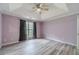Main bedroom featuring tray ceilings, a fan, and a large window at 123 Chippewa Run, Auburn, GA 30011