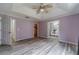 Main bedroom featuring tray ceilings, a fan, and attached bathroom and closet at 123 Chippewa Run, Auburn, GA 30011