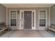 Welcoming front porch with decorative accents, comfortable benches, and a charming entryway at 123 Chippewa Run, Auburn, GA 30011