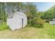 Outdoor shed in backyard surrounded by trees and greenery at 123 Chippewa Run, Auburn, GA 30011