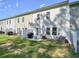The backyard features a small patio with a grill and seating area for relaxing and entertaining at 128 Madison Bnd, Woodstock, GA 30188