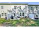 A cozy backyard patio offers a barbecue grill and table with seating for outdoor enjoyment at 128 Madison Bnd, Woodstock, GA 30188