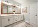 Bathroom showcasing a double sink vanity, a rustic wood-framed mirror, and modern fixtures at 128 Madison Bnd, Woodstock, GA 30188