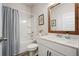 Bathroom with a shower-tub combo, white vanity, and a rustic wood framed mirror at 128 Madison Bnd, Woodstock, GA 30188