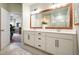 Bathroom view featuring a double sink vanity with white cabinets and a wood framed mirror at 128 Madison Bnd, Woodstock, GA 30188