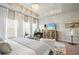 Bright primary bedroom suite featuring a tray ceiling, sitting area, and light color palette at 128 Madison Bnd, Woodstock, GA 30188