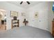 Bedroom showcasing a cozy bed, a mounted TV, decorative art and a storage shelf at 128 Madison Bnd, Woodstock, GA 30188