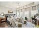 Primary bedroom with decorative pillows, lots of natural light and a seating area at 128 Madison Bnd, Woodstock, GA 30188