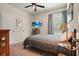 Comfortable bedroom with a ceiling fan, mounted TV, and a cozy bed near a window at 128 Madison Bnd, Woodstock, GA 30188