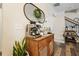 Interior view of a charming coffee station with wood cabinet and designer mirror with greenery at 128 Madison Bnd, Woodstock, GA 30188