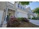 Well-maintained townhome with a two-car garage and lush landscaping at 128 Madison Bnd, Woodstock, GA 30188