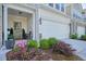 Charming townhome with a two-car garage and inviting curb appeal at 128 Madison Bnd, Woodstock, GA 30188