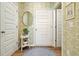 Hallway with hardwood floors, white doors, and decorative wall accents at 128 Madison Bnd, Woodstock, GA 30188